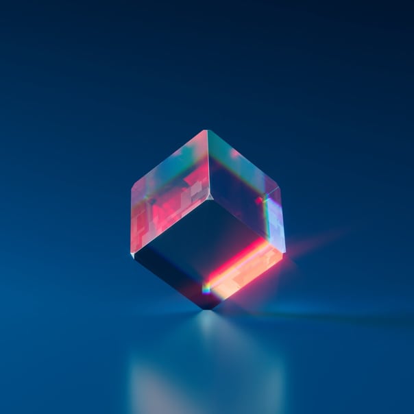 Light refracting through a cube on a dark blue background